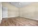 Clean and bright bedroom featuring wood-look floors, a ceiling fan, and a spacious closet at 4830 Summerbridge Cir, Leesburg, FL 34748