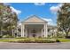 Beautiful clubhouse exterior featuring manicured landscaping and a stately entrance at 4830 Summerbridge Cir, Leesburg, FL 34748