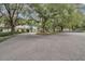 Clubhouse exterior surrounded by lush greenery with golf carts in the parking area at 4830 Summerbridge Cir, Leesburg, FL 34748