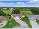 Lovely single-story home featuring a brick-paved driveway, well-manicured lawn, and mature landscaping at 4830 Summerbridge Cir, Leesburg, FL 34748