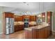 Spacious kitchen with stainless steel appliances, wooden cabinetry, and granite countertops at 4830 Summerbridge Cir, Leesburg, FL 34748