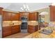 Gourmet kitchen showcasing granite countertops, tile backsplash, stainless steel appliances, and wood cabinets at 4830 Summerbridge Cir, Leesburg, FL 34748