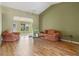Spacious living room with wood floors, vaulted ceilings, and comfortable seating arrangement at 4830 Summerbridge Cir, Leesburg, FL 34748