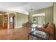 Spacious living room with hardwood floors, comfortable seating, and plenty of natural light at 4830 Summerbridge Cir, Leesburg, FL 34748