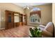 Living room features a custom wood entertainment center, neutral paint, and a large window with decorative shutters at 4830 Summerbridge Cir, Leesburg, FL 34748
