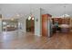 Open floor plan featuring a kitchen with stainless steel appliances and a living room with a comfortable sofa at 4830 Summerbridge Cir, Leesburg, FL 34748