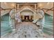 Grand lobby featuring dual staircases, elegant lighting, and an open floor plan at 4830 Summerbridge Cir, Leesburg, FL 34748