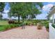 Brick paved patio featuring well manicured landscaping, mature trees, and outdoor seating at 4830 Summerbridge Cir, Leesburg, FL 34748