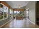 Bright sunroom with neutral paint, many windows, and tiled floor provides beautiful views of the landscape at 4830 Summerbridge Cir, Leesburg, FL 34748