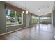 Bright sunroom with large windows and tiled floor offers scenic views and a relaxing atmosphere at 4830 Summerbridge Cir, Leesburg, FL 34748