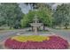 Decorative water fountain surrounded by flowers and greenery along the main drive at 4830 Summerbridge Cir, Leesburg, FL 34748