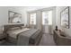 Relaxing bedroom featuring neutral tones, dresser with contemporary lamp and two large windows for natural light at 494 Belmond Dr, Debary, FL 32713