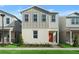 Charming two-story home featuring light gray siding, red front door, and well-maintained landscaping at 494 Belmond Dr, Debary, FL 32713
