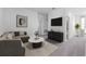 Cozy living room featuring neutral decor, comfortable seating, and a sleek entertainment center at 494 Belmond Dr, Debary, FL 32713