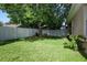 Well-maintained backyard features a large tree and a white fence around the property at 4954 Alavista Dr, Orlando, FL 32837