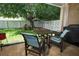 Outdoor patio with lawn, complemented by a white picket fence, a tree, and a grill at 4954 Alavista Dr, Orlando, FL 32837