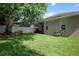 A spacious backyard featuring a well-maintained lawn and a charming white picket fence at 4954 Alavista Dr, Orlando, FL 32837