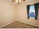 Neutral bedroom featuring a window with a curtain and tan carpeting at 4954 Alavista Dr, Orlando, FL 32837