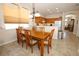 Bright dining area adjacent to kitchen features a wooden table, chairs, and warm, inviting lighting at 4954 Alavista Dr, Orlando, FL 32837