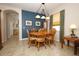 Inviting dining area with an elegant chandelier, wood table, and cozy chairs, perfect for gatherings at 4954 Alavista Dr, Orlando, FL 32837