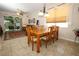 An interior view of a dining room features a wooden table set, with a living area beyond at 4954 Alavista Dr, Orlando, FL 32837