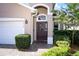 Close-up showcasing the front door with decorative glass, a paver walkway, and manicured landscaping at 4954 Alavista Dr, Orlando, FL 32837