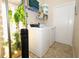 Laundry room with modern washer and dryer, shelves, and indoor hydroponic garden at 4954 Alavista Dr, Orlando, FL 32837