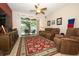 Cozy living room with large area rug and sliding glass doors leading to outdoor seating area at 4954 Alavista Dr, Orlando, FL 32837