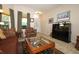Comfortable living room featuring tile flooring, a fish tank, and natural light at 4954 Alavista Dr, Orlando, FL 32837