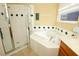 This bright bathroom features a large soaking tub with a shower and large vanity at 4954 Alavista Dr, Orlando, FL 32837