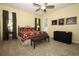 Bright main bedroom features neutral carpeting, ceiling fan, and a door to the backyard at 4954 Alavista Dr, Orlando, FL 32837