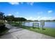 Scenic view of Vista Lake with a paved walking path, lush greenery, and clear signage at 4954 Alavista Dr, Orlando, FL 32837