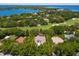 Aerial view of the home surrounded by lush trees, a golf course, and a lake at 5199 Latrobe Dr, Windermere, FL 34786