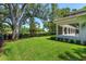 Expansive backyard with lush green grass and landscaping next to golf course at 5199 Latrobe Dr, Windermere, FL 34786