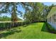 Expansive backyard with lush green grass and landscaping next to golf course at 5199 Latrobe Dr, Windermere, FL 34786