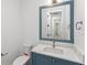 Powder room featuring marble countertop and framed mirror at 5199 Latrobe Dr, Windermere, FL 34786
