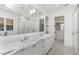 Bathroom featuring dual sinks, a marble countertop, and a glass-enclosed shower at 5199 Latrobe Dr, Windermere, FL 34786