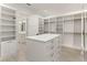 Walk-in closet with custom shelving and a central island with drawers at 5199 Latrobe Dr, Windermere, FL 34786