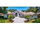 Stunning exterior of a home with meticulous landscaping and a permeable paver driveway at 5199 Latrobe Dr, Windermere, FL 34786