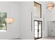 Bright foyer with high ceilings, large windows, and stylish chandeliers at 5199 Latrobe Dr, Windermere, FL 34786
