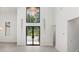 Bright foyer with high ceilings, large windows, and stylish lighting at 5199 Latrobe Dr, Windermere, FL 34786