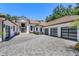 Beautiful home's exterior highlighting the permeable paver driveway and three-car garage at 5199 Latrobe Dr, Windermere, FL 34786