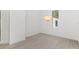 Minimalist, bright living room with grey tile floor and a stylish chandelier at 5199 Latrobe Dr, Windermere, FL 34786
