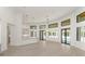 Bright, open-concept living room featuring a modern kitchen, high ceilings, and access to the pool at 5199 Latrobe Dr, Windermere, FL 34786