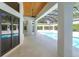 Outdoor pool area features open patio, ceiling fan, and screened-in enclosure at 5199 Latrobe Dr, Windermere, FL 34786