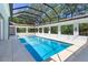 Outdoor pool area features screened-in enclosure and a bright blue swimming pool at 5199 Latrobe Dr, Windermere, FL 34786