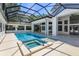 Outdoor pool area with spa features screened-in enclosure and a bright blue swimming pool at 5199 Latrobe Dr, Windermere, FL 34786
