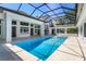 Outdoor pool area features screened-in enclosure and a bright blue swimming pool at 5199 Latrobe Dr, Windermere, FL 34786