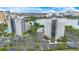 Stunning aerial view of the modern apartment complex, showcasing its convenient parking and serene waterfront location at 6165 Carrier Dr # 2605, Orlando, FL 32819