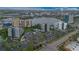 An aerial view showing the proximity to a lake, parking, and surrounding neighborhood near this condominium community at 6165 Carrier Dr # 2605, Orlando, FL 32819